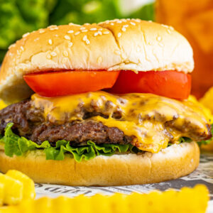 square image of a smash burger next to french fries