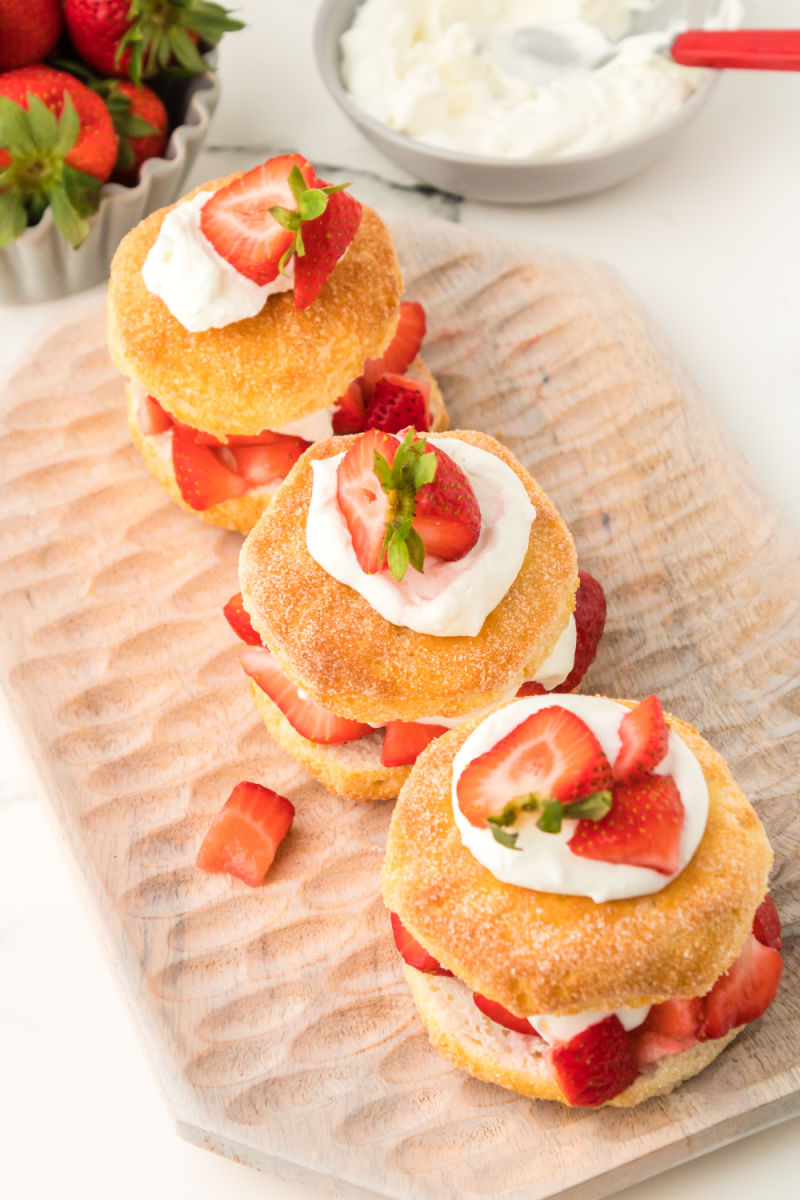 three biscuit strawberry shortcakes on a platter