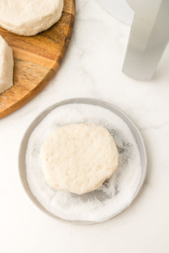 refrigerated biscuit coated in sugar on a small plate