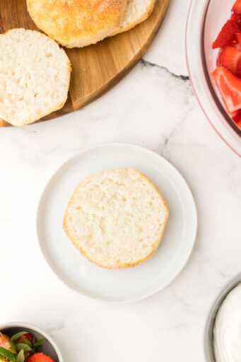 biscuit for strawberry short cake cut in half on a small plate