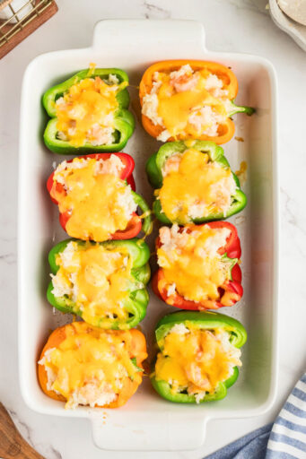 baked shrimp stuffed peppers in a baking dish