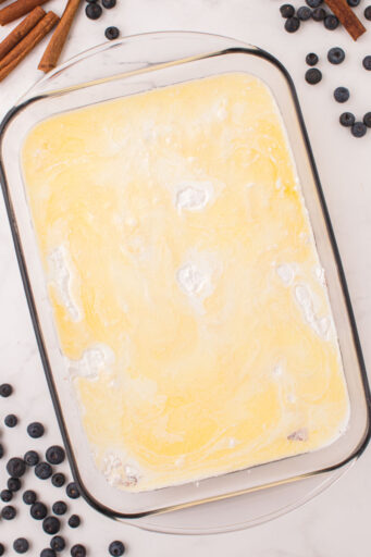 butter and half-and-half mixture poured over cake mix to make blueberry cobbler