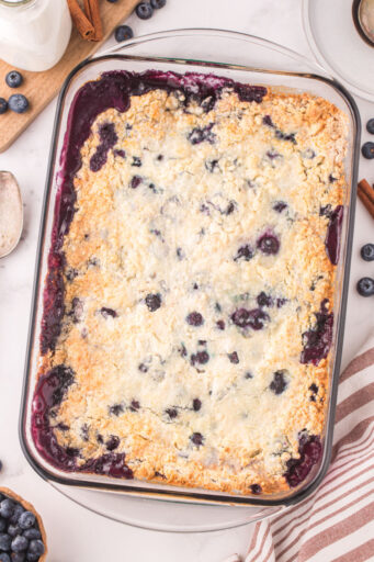 baked blueberry cobbler in a glass dish