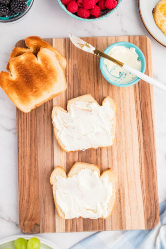 two pieces of toast with mayo spread over the top