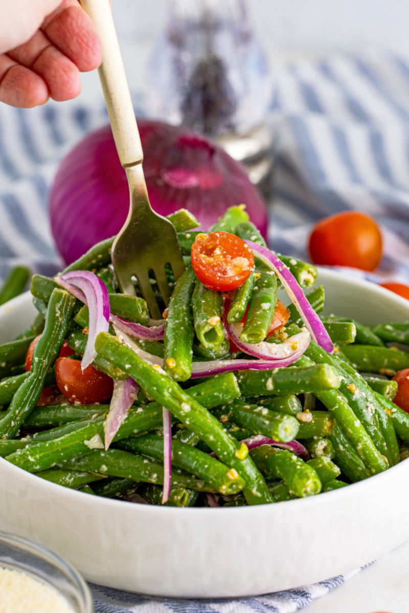 fork stabbing into a bowl of green bean salad