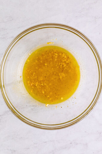 green bean salad dressing in a large glass mixing bowl