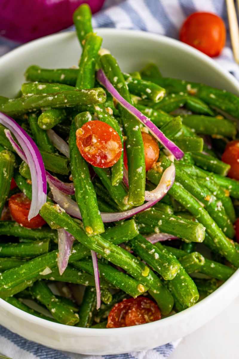 close up of marinated green bean salad in a serving bowl