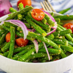 square image of cold green bean salad in a serving bowl