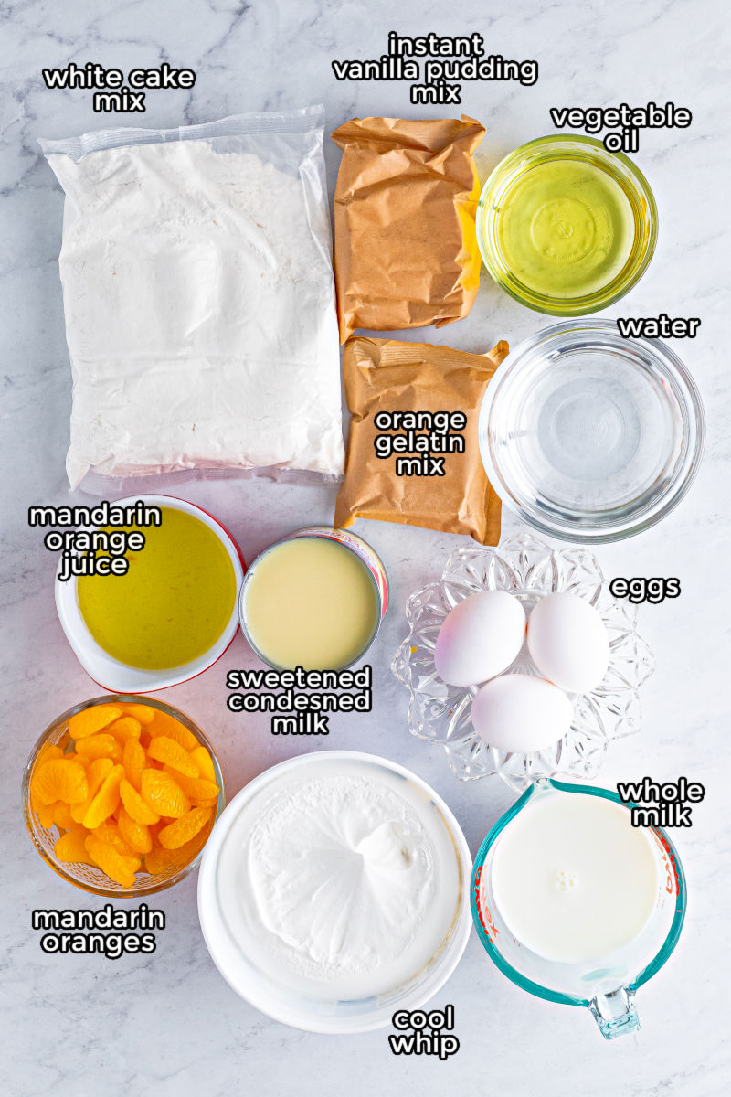 ingredients to make orange creamsicle cake laid out on a counter with text labels