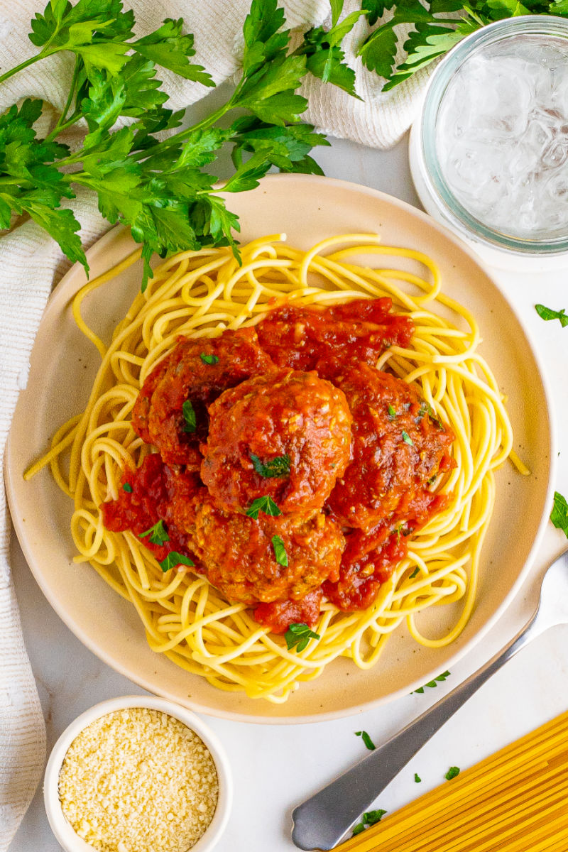 looking down at a plate of pasta and italian meatballs