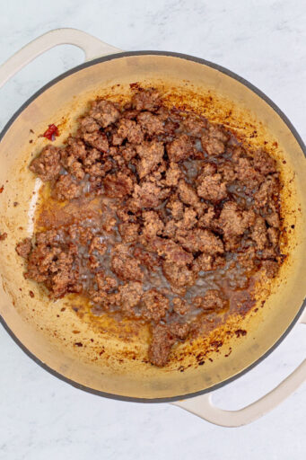 cooked ground beef in a pot with bacon drippings