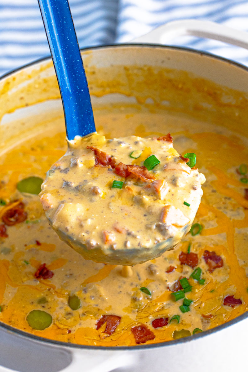 ladleful of bacon cheeseburger soup over the pot