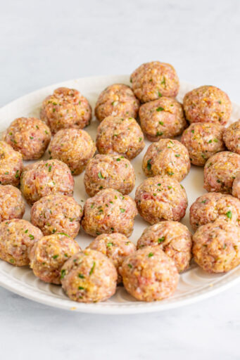 raw meatballs on a plate after being rolled