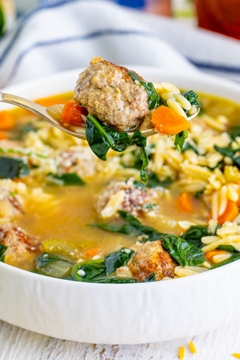 spoonful of italian wedding soup over the bowl