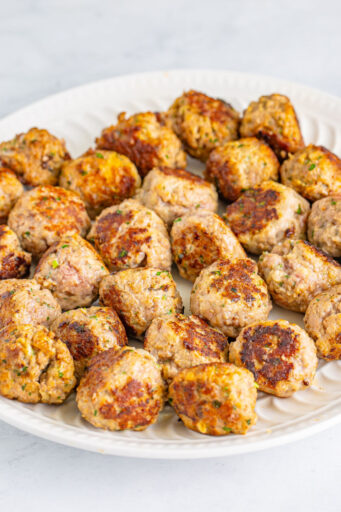 cooked meatballs on a plate after being browned