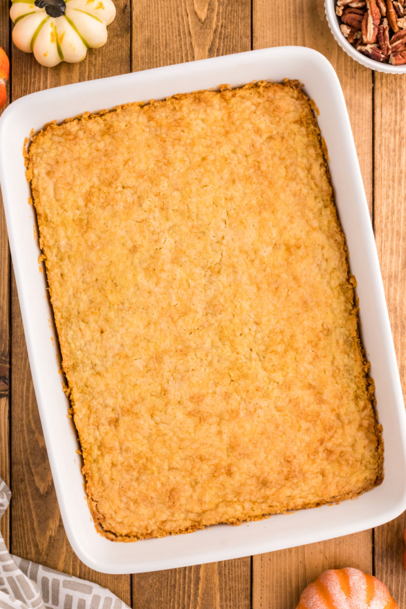 looking down at a pumpkin pie cake in a white 9x13 baking dish