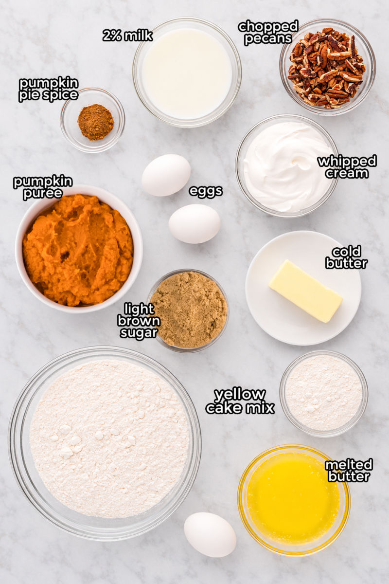 ingredients to make pumpkin pie cake in bowls on a counter, with text labels