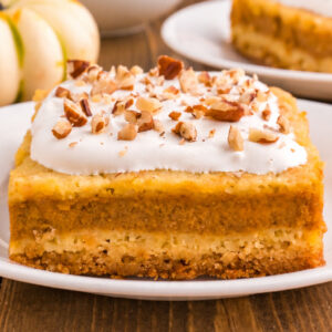 square image of a slice of pumpkin pie cake on a small white plate