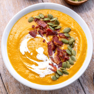 square image of sweet potato soup in a white bowl